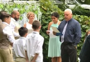 A picturesque backyard wedding ceremony, adorned with flowers and decorations, celebrating love in an intimate setting